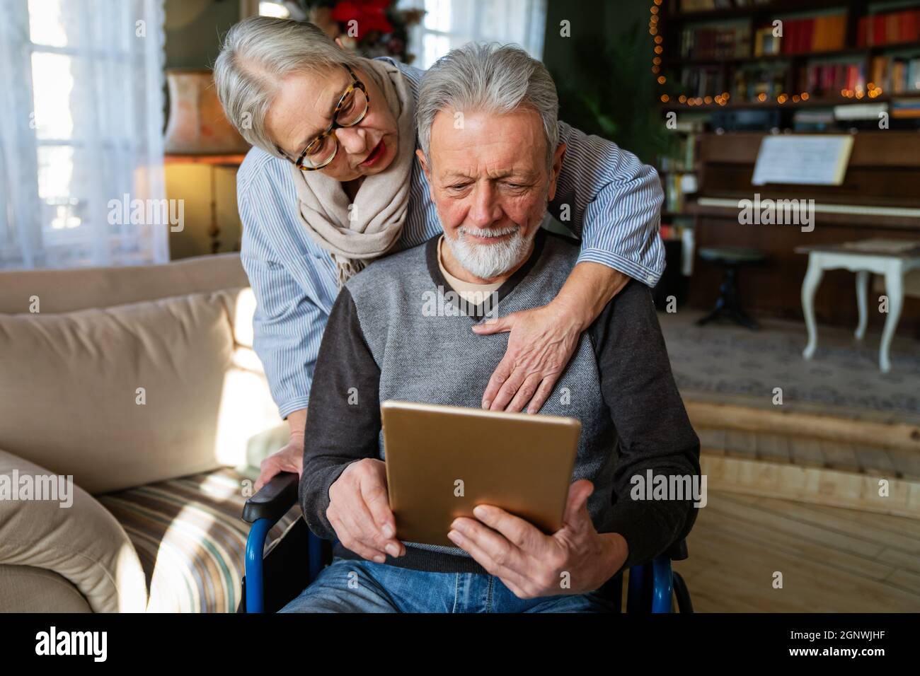 Senior couple having fun and laughing while using their tablet pc computer. Stock Photo