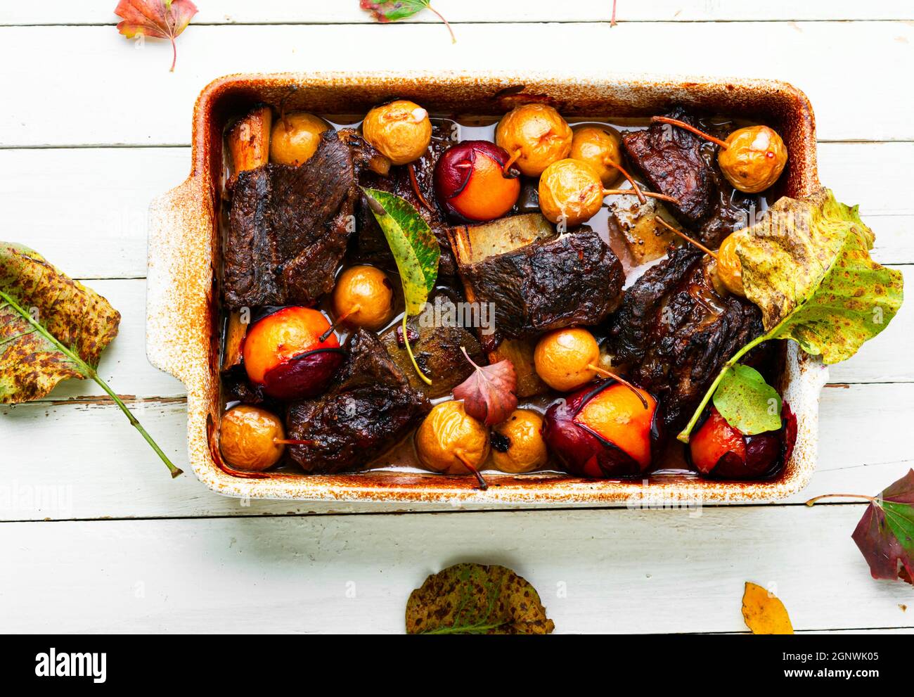 Beef ribs roasted in plums and pears.Grilled meat in fruit sauce Stock