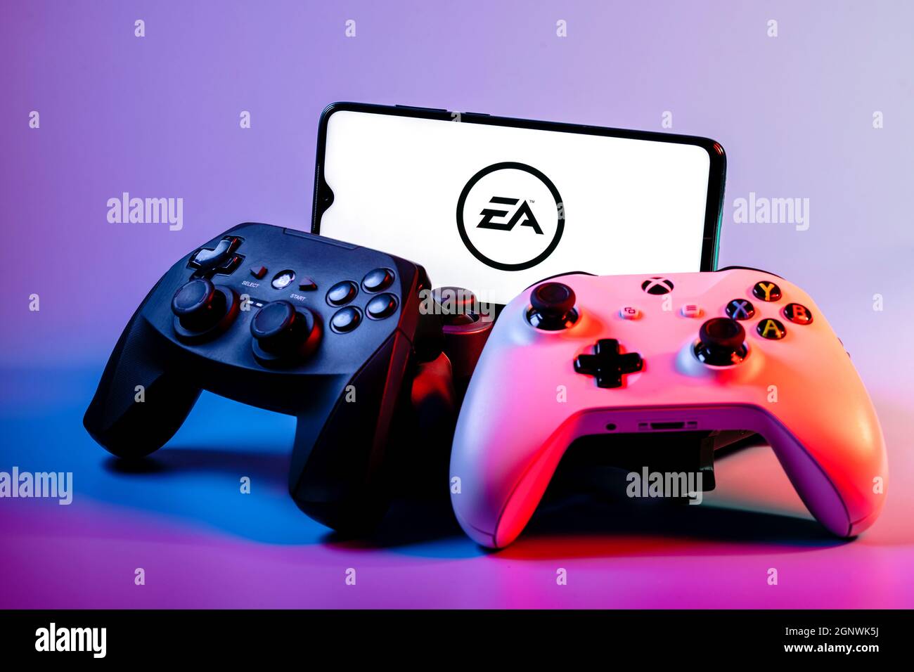 A smartphone with the Electronic Arts logo on the screen on the pile of the  gamepads Stock Photo - Alamy
