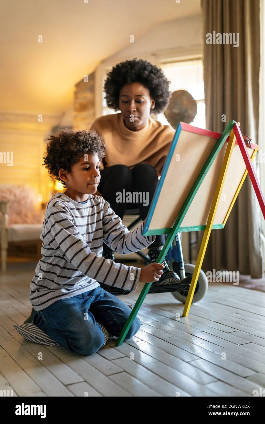 Happy child doing math exercises with her mother ot teacher together. Education people fun concept Stock Photo