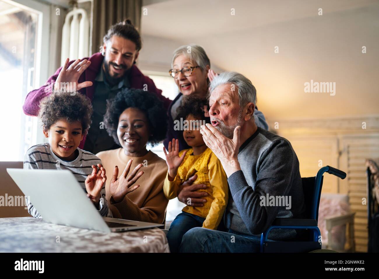 Extended multiethnic family together at home during video call. People happiness technology concept Stock Photo