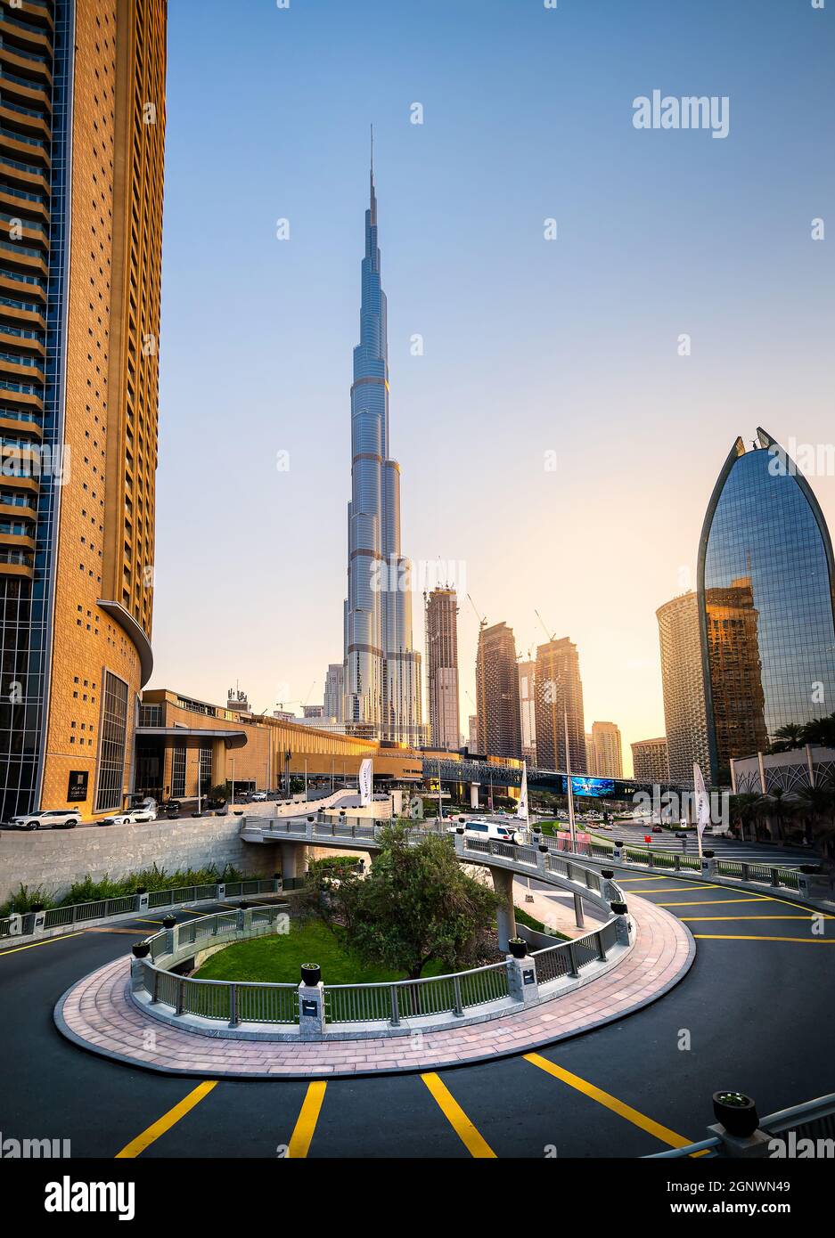 Dubai, United Arab Emirates - April 19, 2021: Dubai mall and Burj Khalifa modern architecture and downtown city streets area streets at scenic sunset Stock Photo