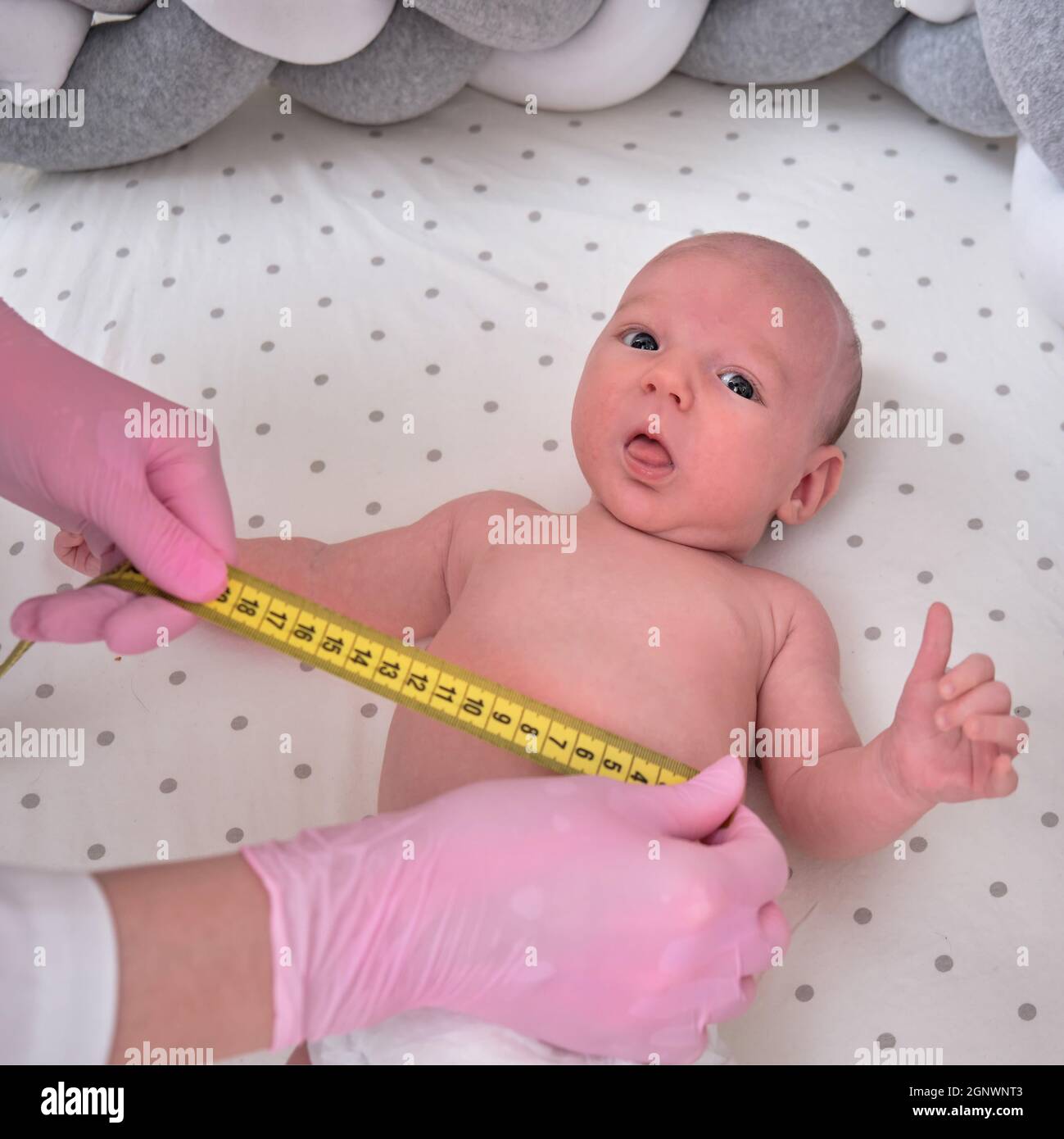Doctor measuring baby head circumference. Pediatrician place