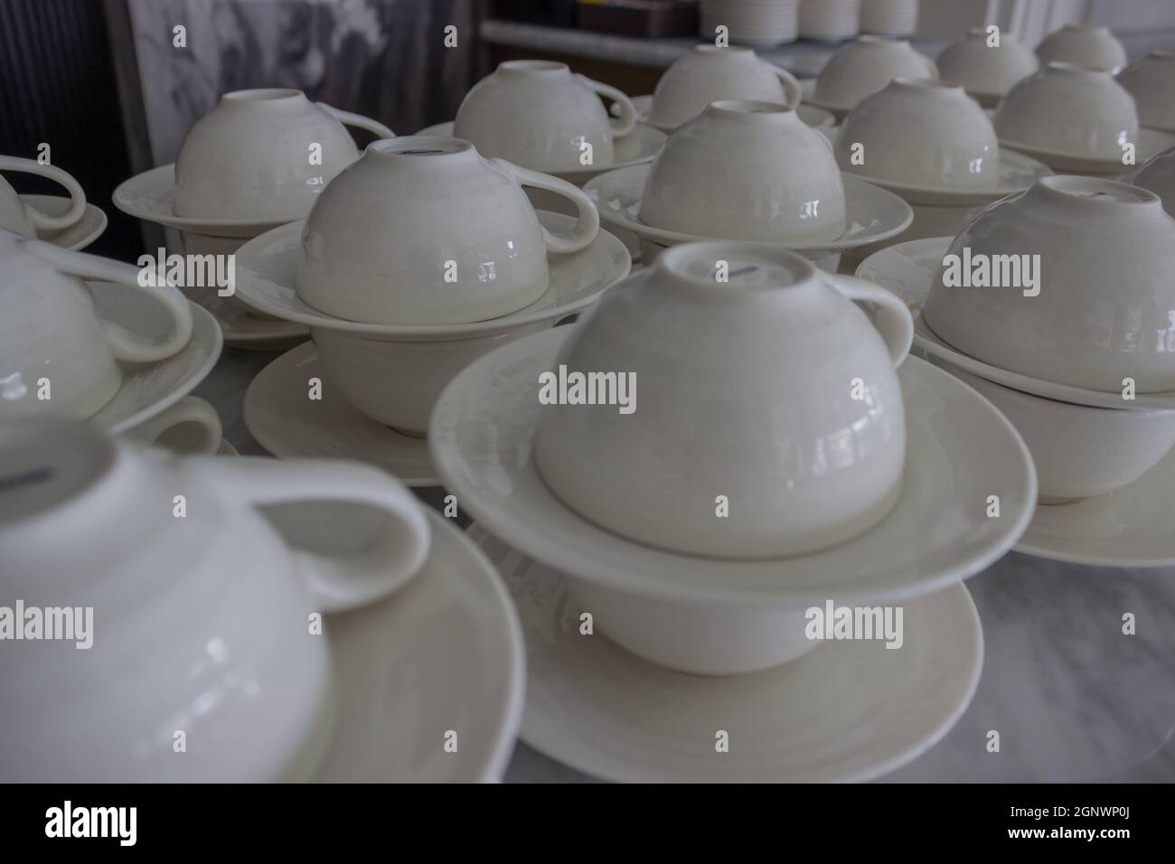 set of white ceramic cup and saucers display in restaurant Stock Photo