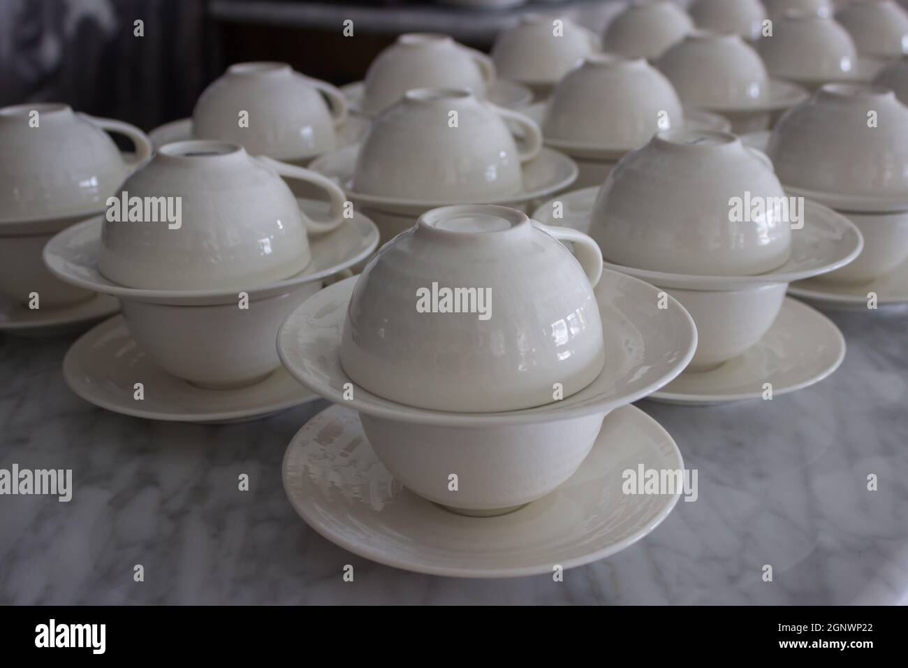 set of white ceramic cup and saucers display in restaurant Stock Photo