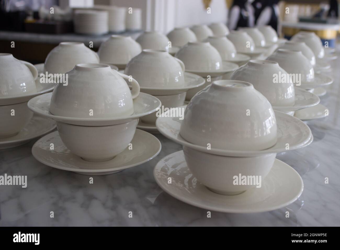 set of white ceramic cup and saucers display in restaurant Stock Photo