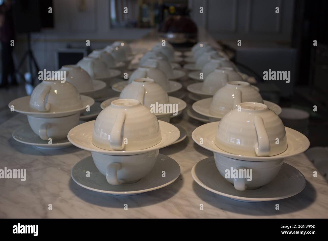 set of white ceramic cup and saucers display in restaurant Stock Photo