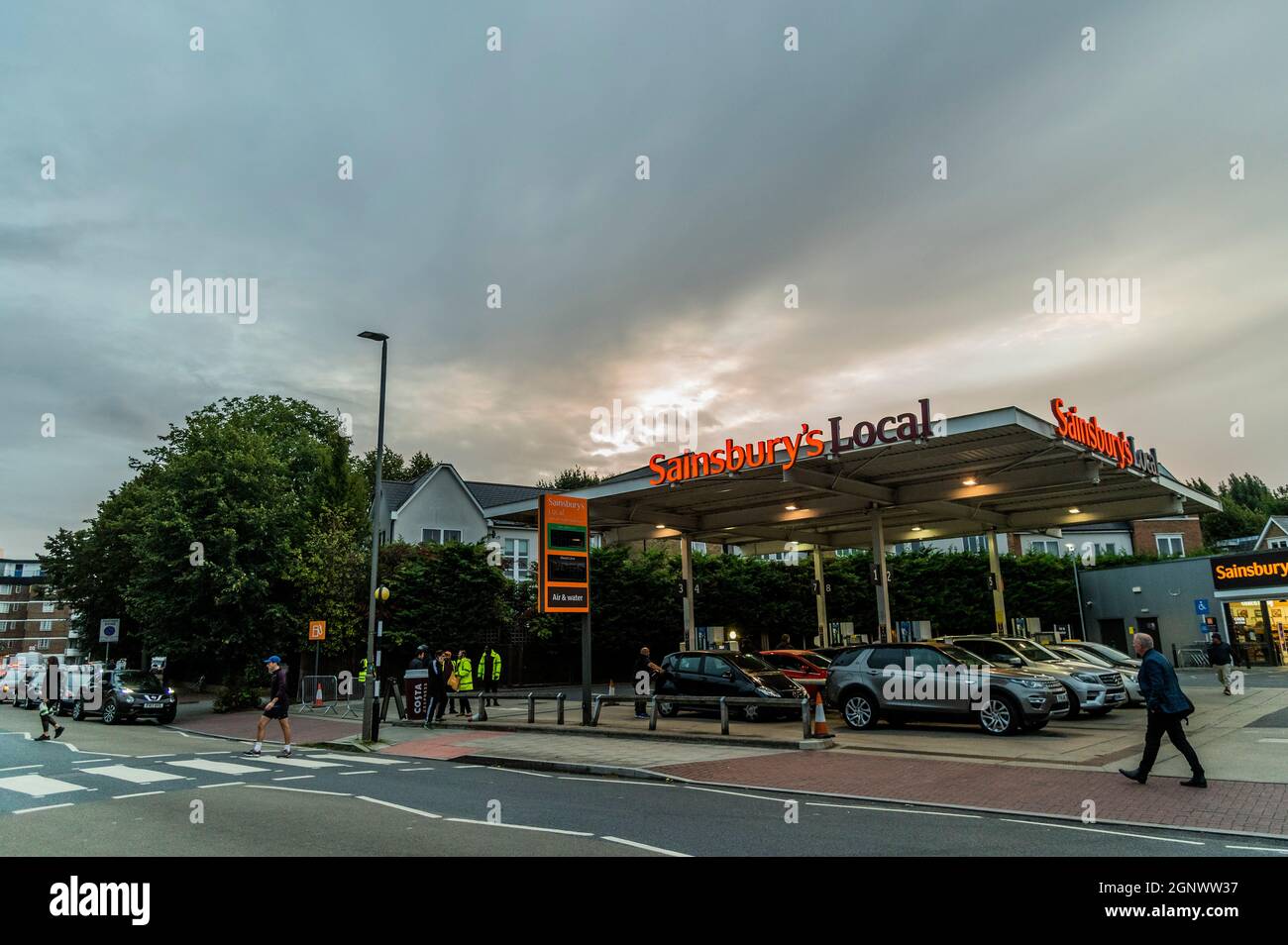 London, UK. 28th Sep, 2021. Fuel shortages escalate due to panic buying, as Sainsburys near Clapham South is now open again with long queues. The shortage is a result of a lack of tanker drivers due to the extended impact of Brexit on European migrant workers. Credit: Guy Bell/Alamy Live News Stock Photo