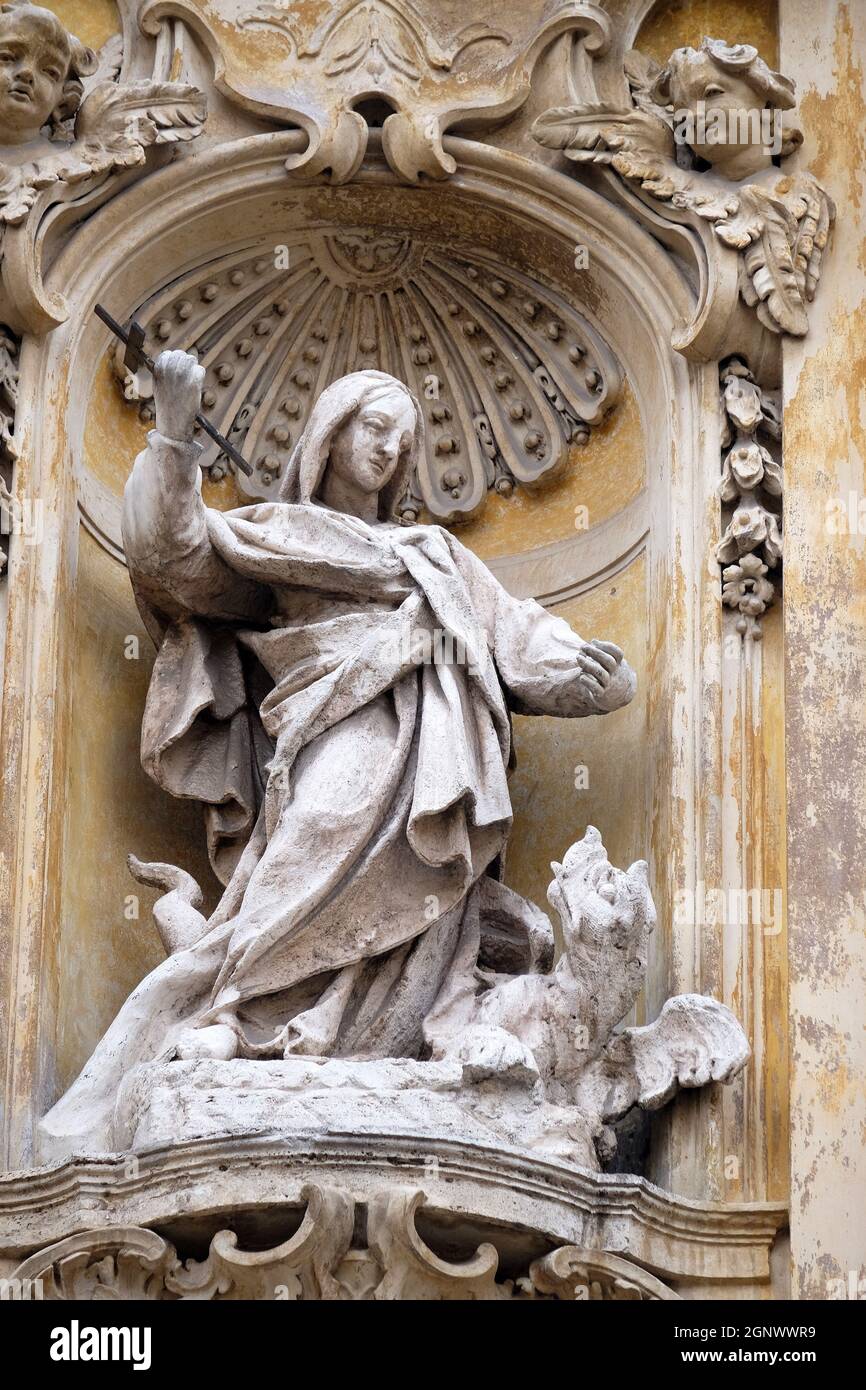 Statue of Saint Martha of Bethany on facade of Santa Maria Maddalena Church in Rome, Italy Stock Photo