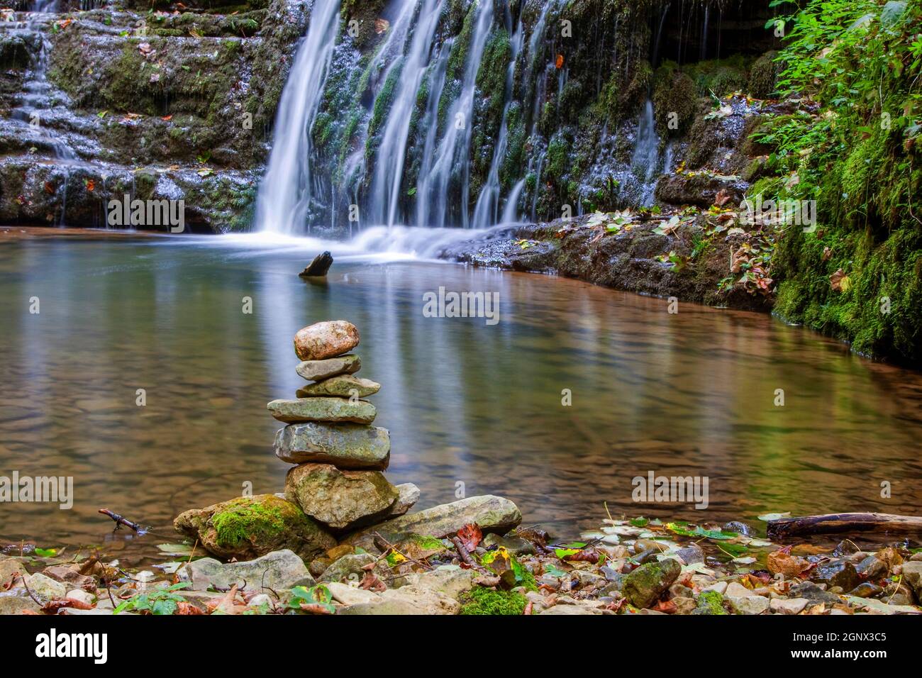 Stack of stones at a waterfall in the Gauchach Gorge in the Black Forest in Germany Stock Photo