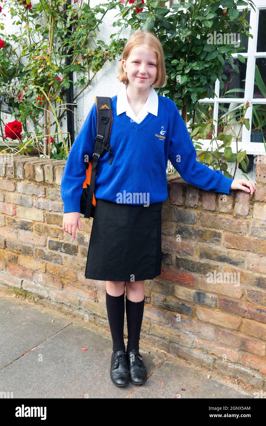 Year 7 girl / schoolgirl student / pupil / child / kid in new uniform leaving home on the first 1st day of school at the start of Secondary. UK (127) Stock Photo