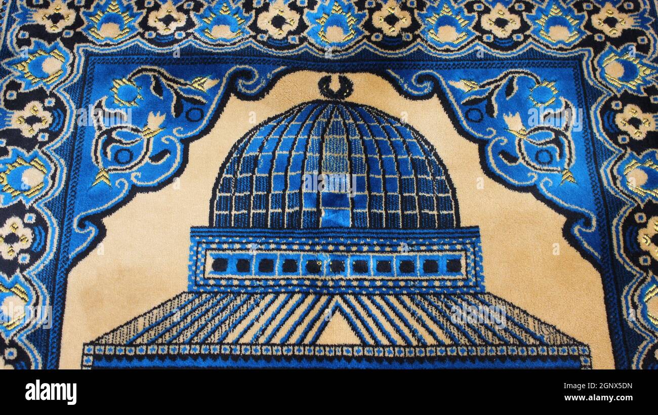 Closeup view of prayer rug in place to make prayer. High angle view of ...