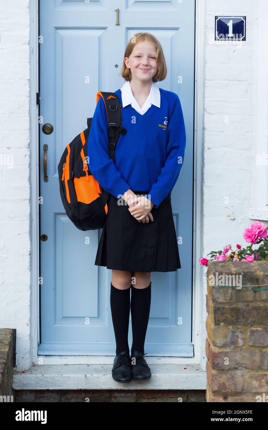 Year 7 girl / schoolgirl student / pupil / child / kid in new uniform leaving home on the first 1st day of school at the start of Secondary. UK (127) Stock Photo