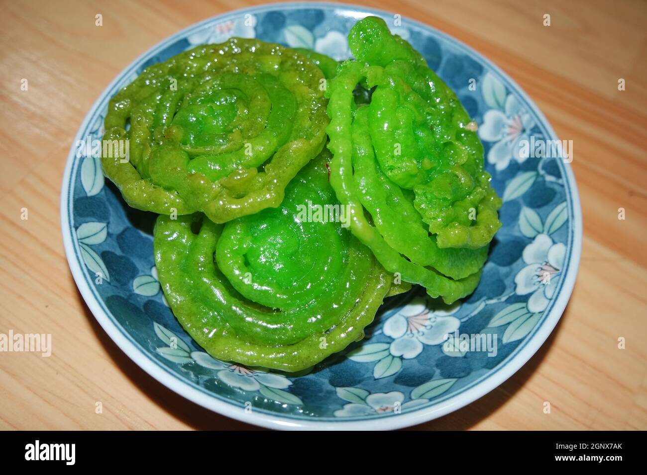 Crispy sweet Asian dessert green Jalebi cooked and served in ceramic