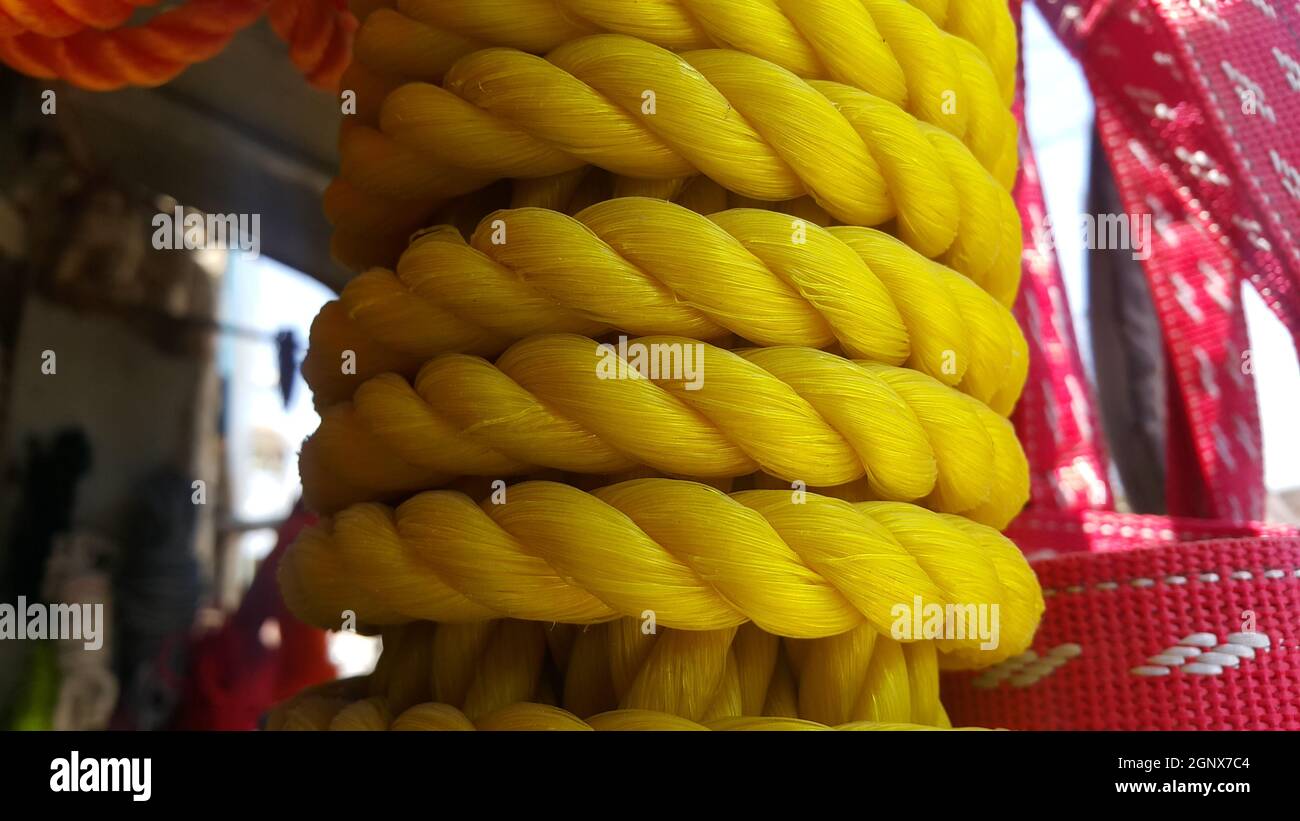 Closeup of bright color braided plastic ropes. Hanks or coil of bright colored plastic rope
