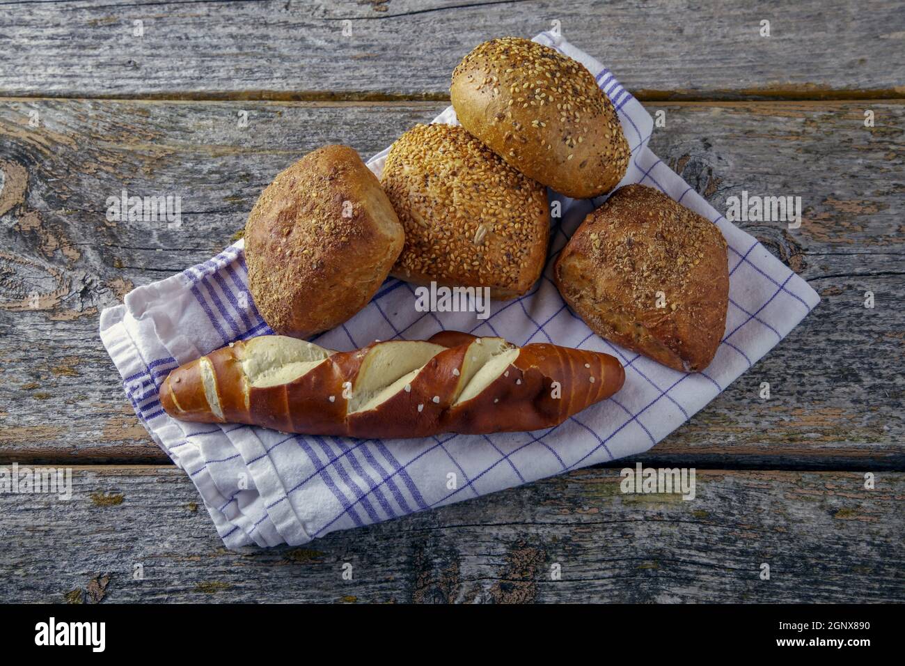 bread on kitchen towel on a rustic wooden background Stock Photo