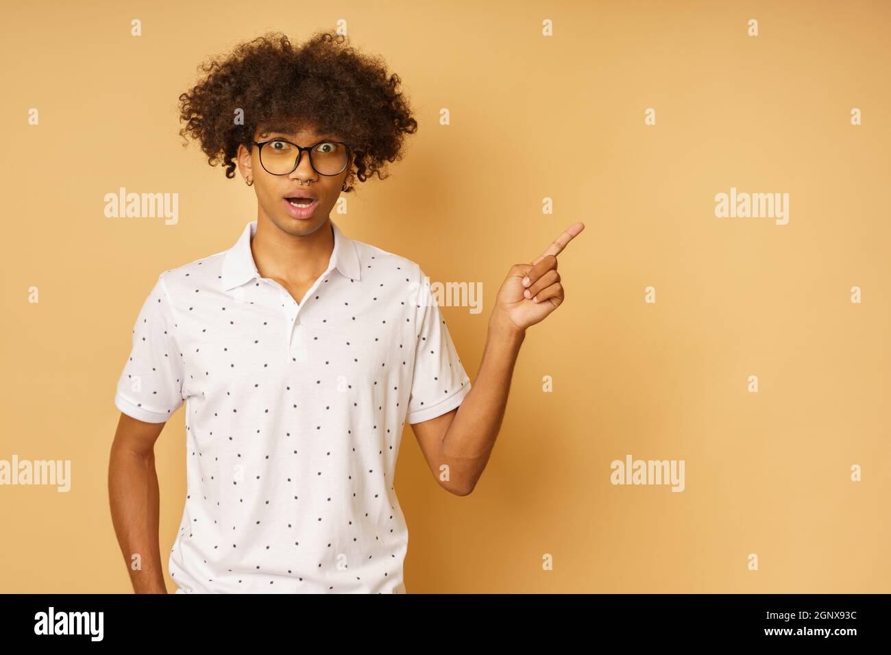 Amazed man with glasses indicates something with hand Stock Photo