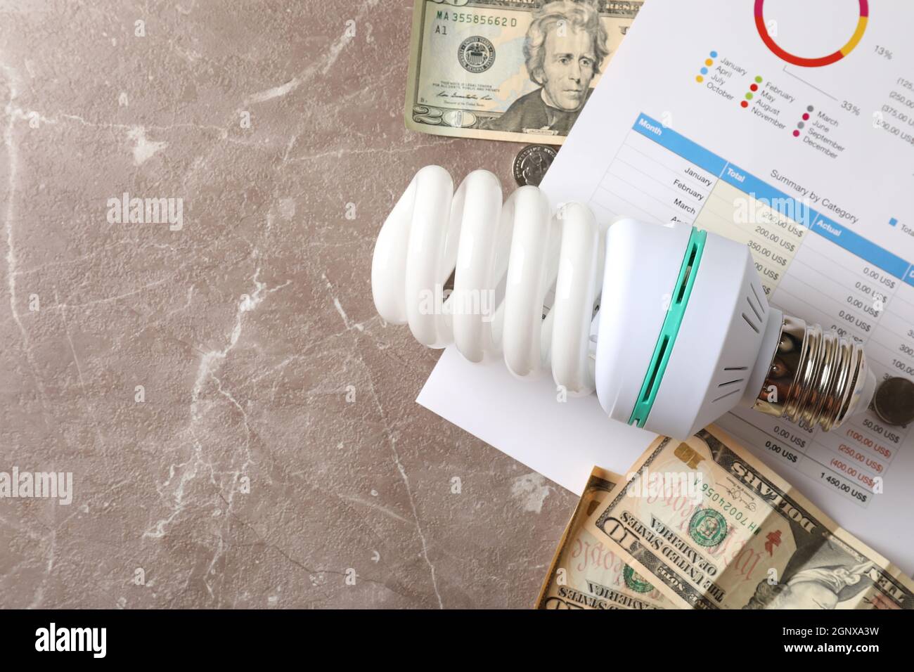 Energy saving concept on gray textured background. Stock Photo
