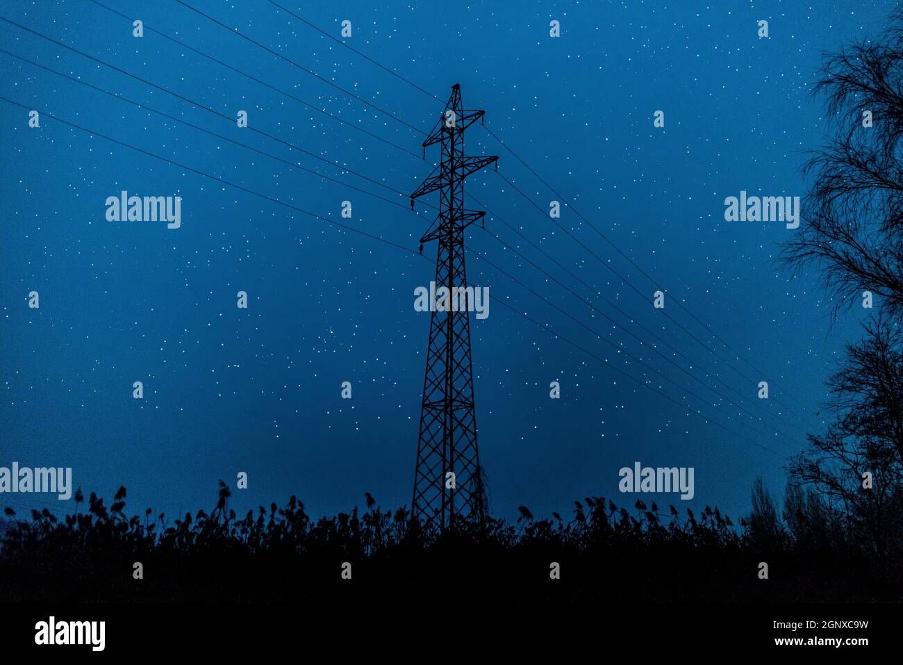 silhouette of high voltage electric power transmission lines tower, in ...