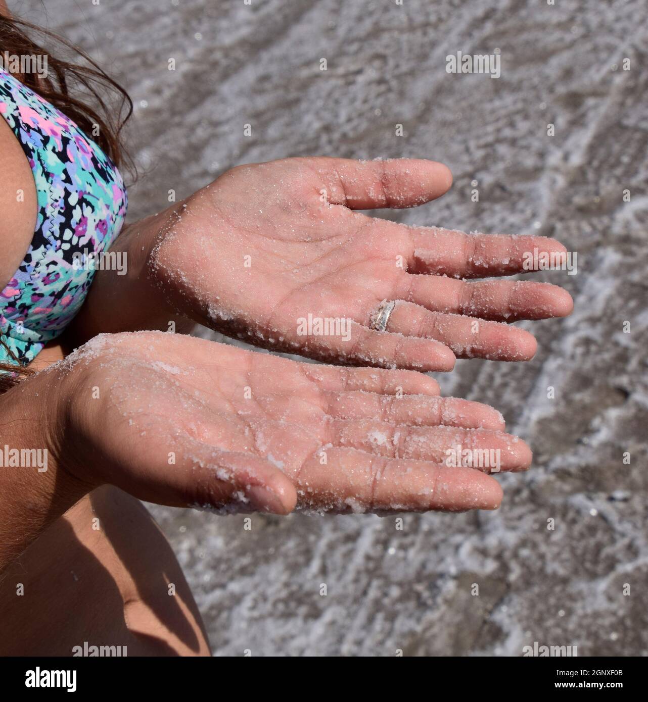 Woman Using Salt Salt on the girl's hands. Dried salt on the hands of women of the ...