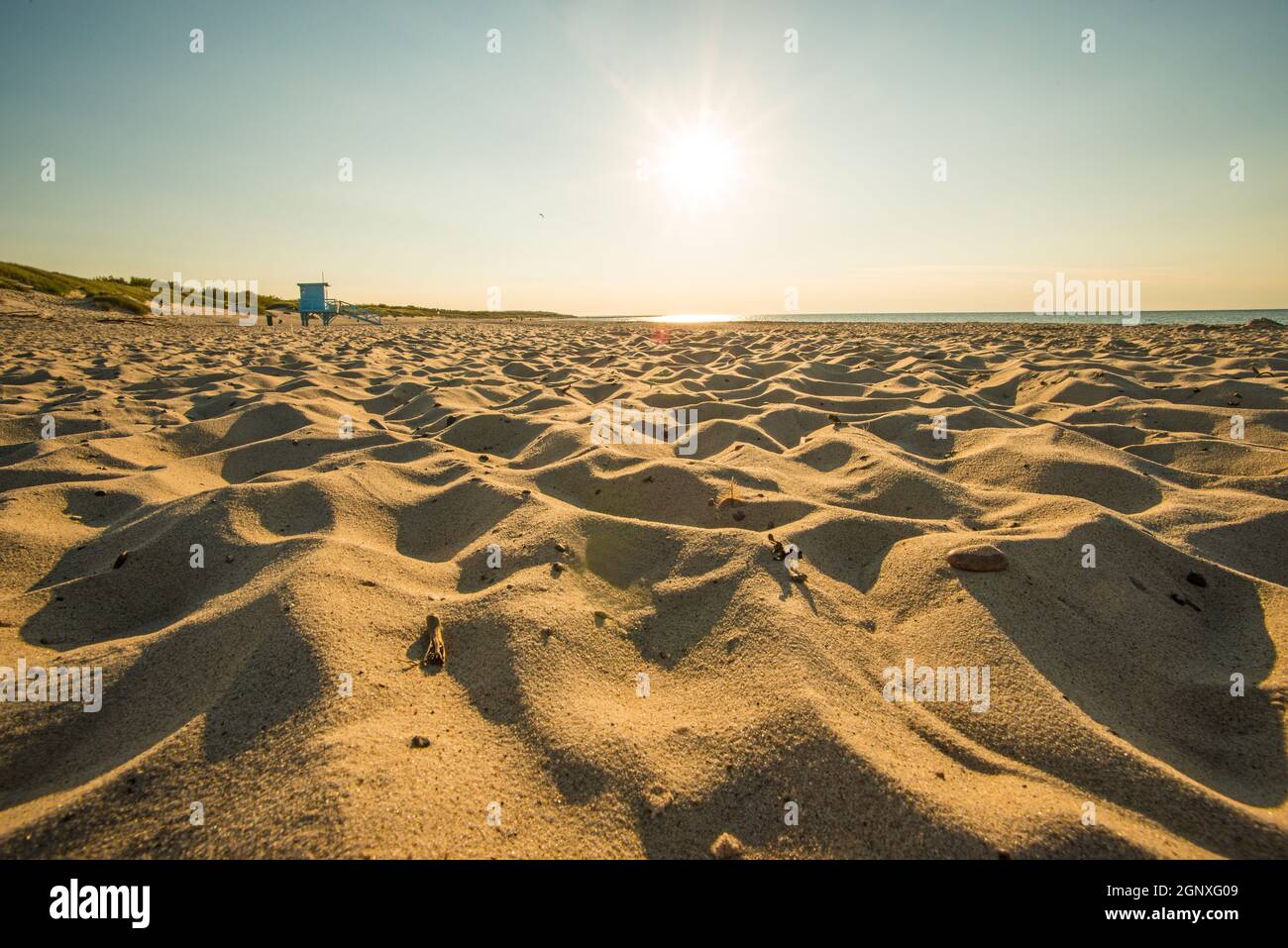beach of the Baltic Sea with evening sun and sand patterns Stock Photo
