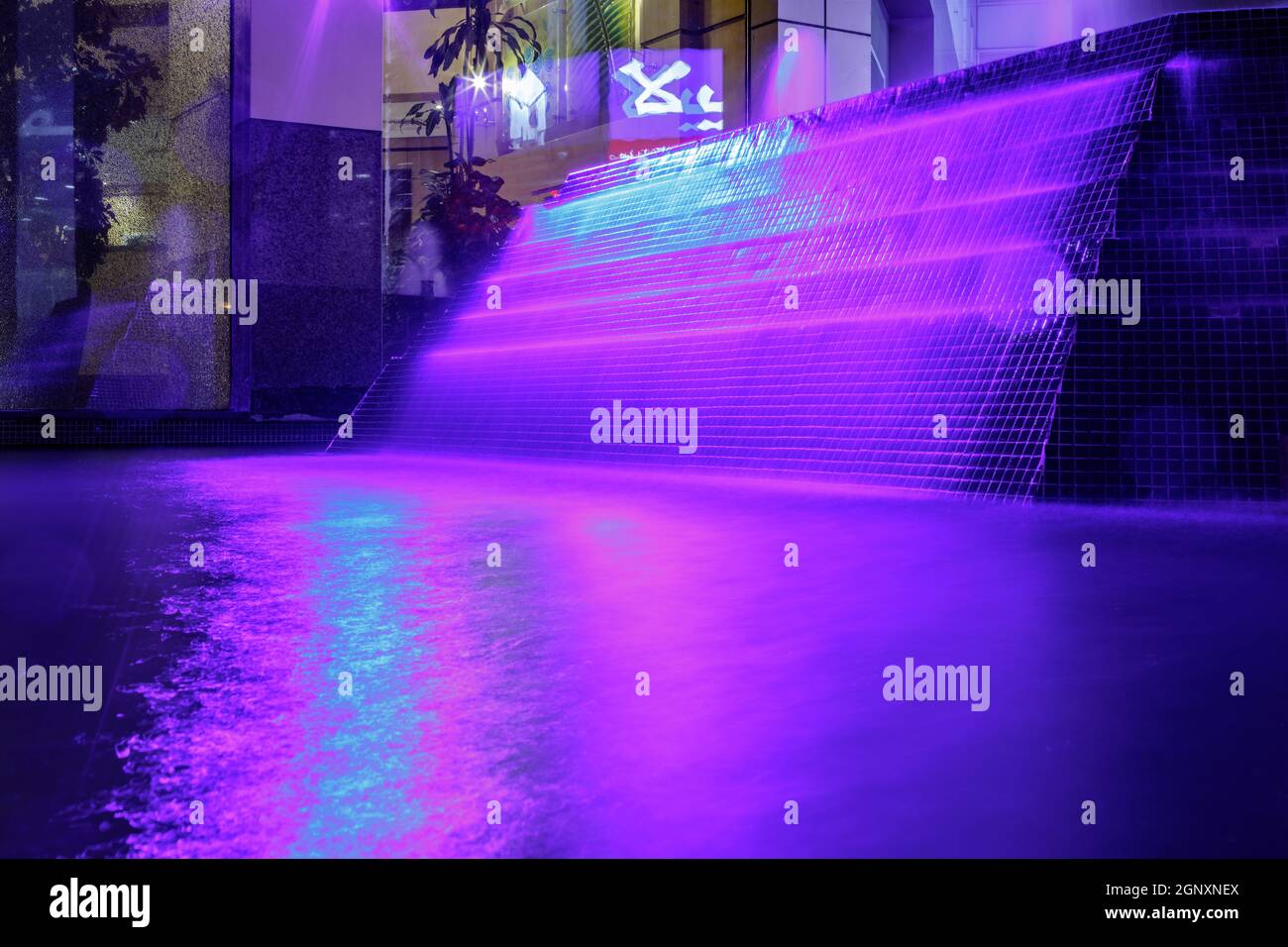 Beautiful purple illuminated fountain at night in Dubai Stock Photo - Alamy