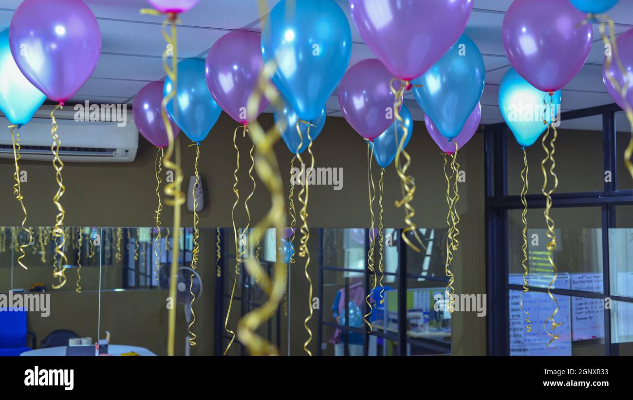 Closeup shot of colorful balloons hanging from the ceiling for a