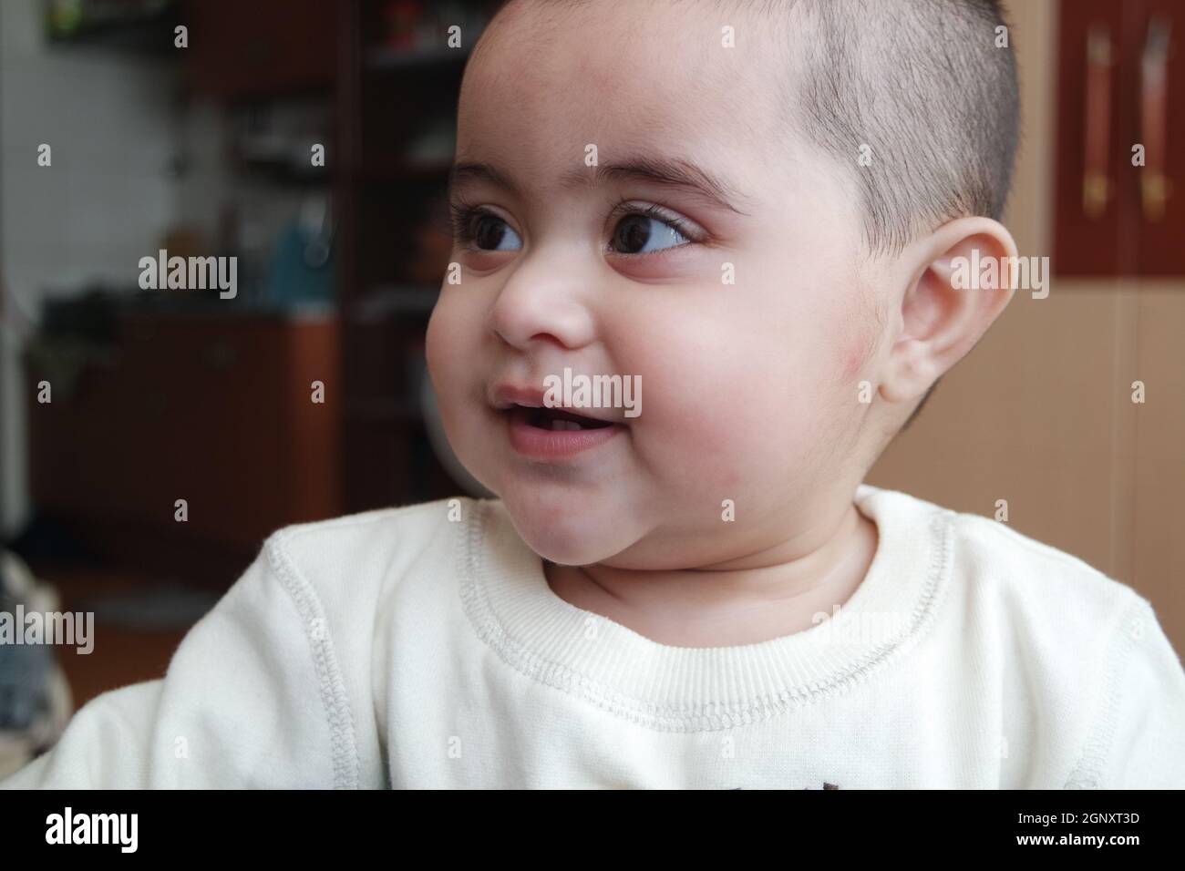 Portrait of a baby girl with smiling face, big eyes and lovely face gesture Stock Photo