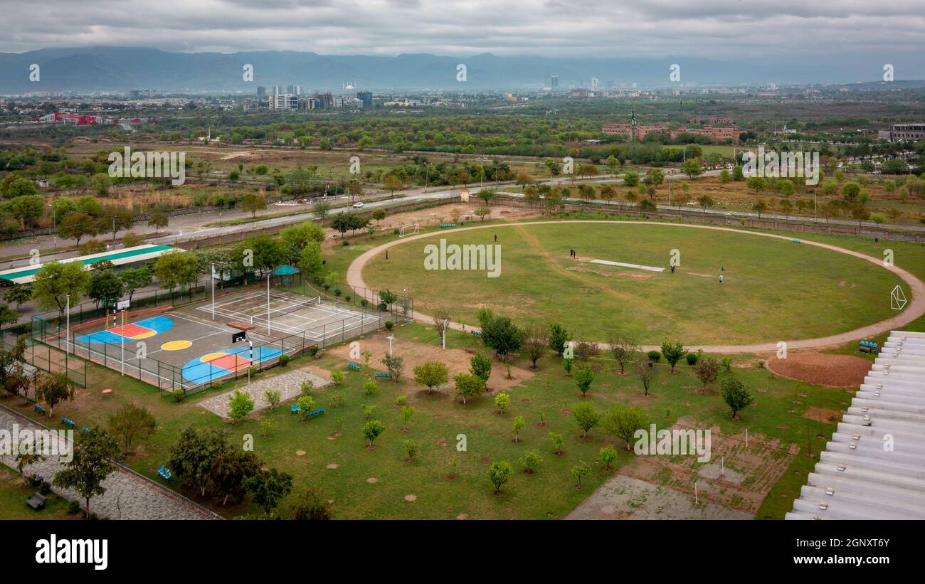 Aerial view of basketball and tennis courts, footy field against the