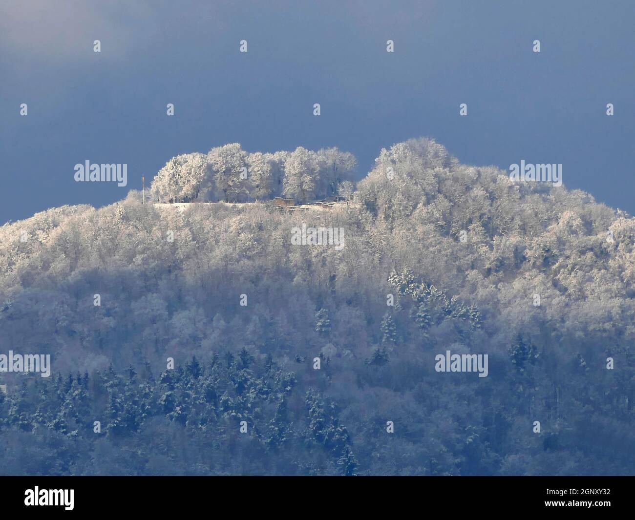 view in winter to the emperor hill Hohenstaufen with snow and sun in Germany Stock Photo