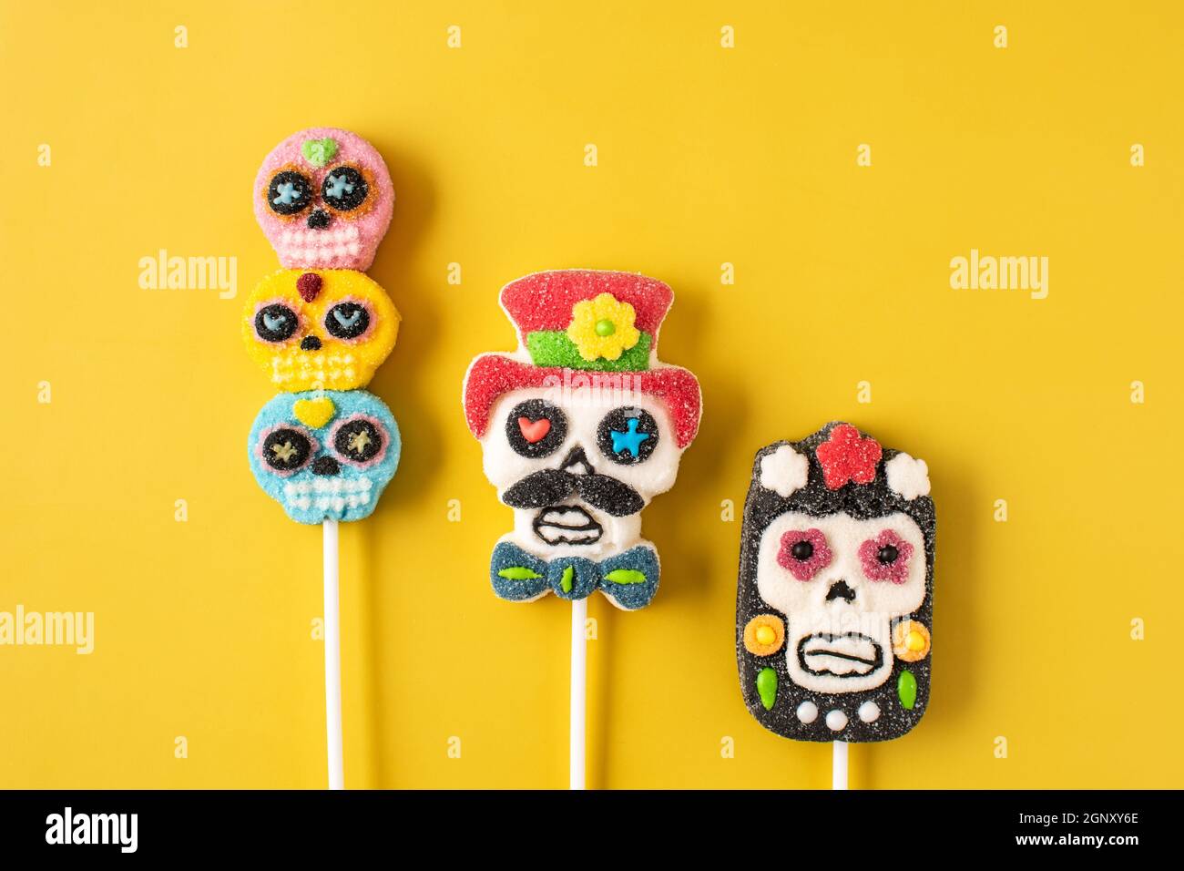 Candy skull lollipops on yellow background Stock Photo