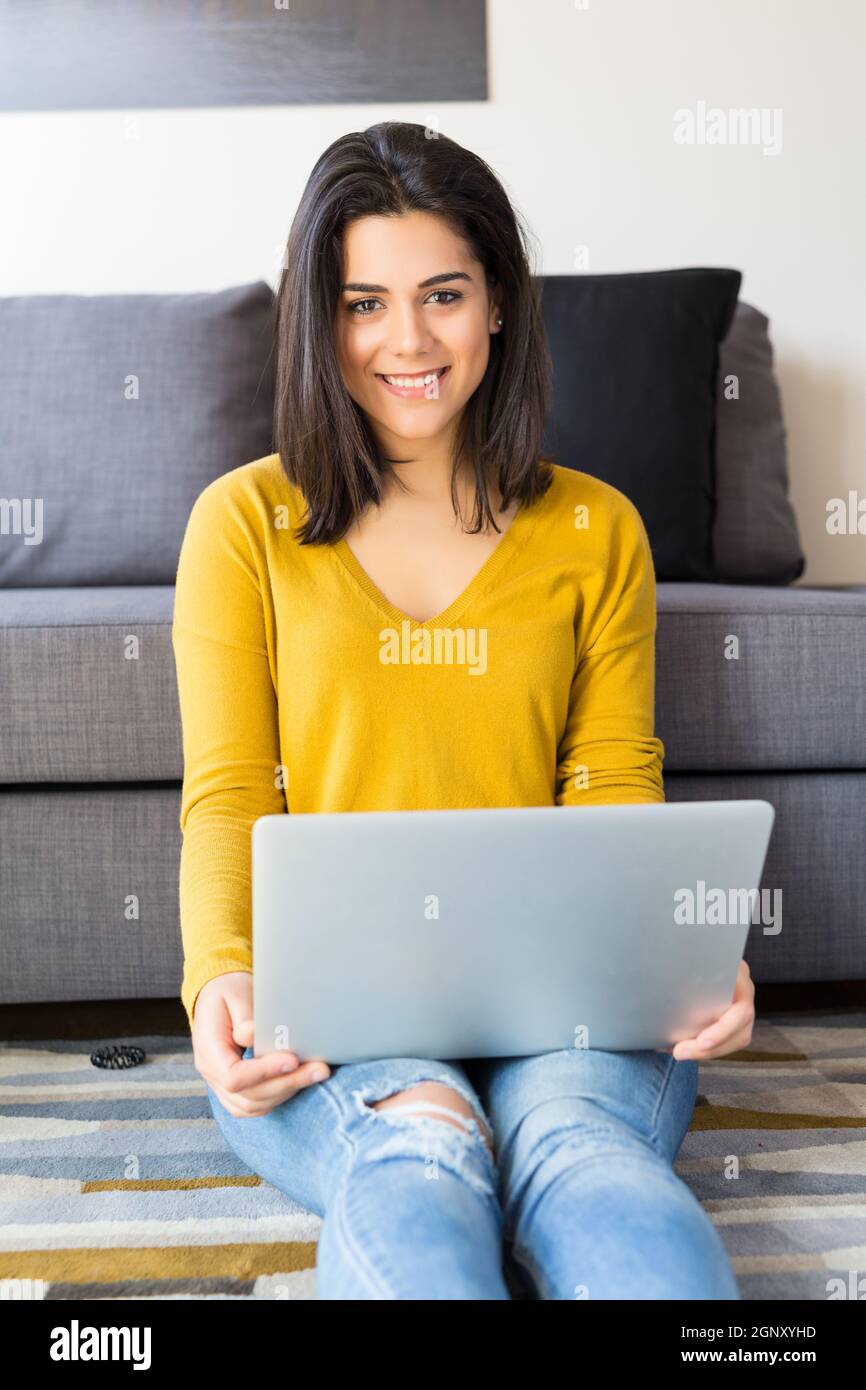 Beautiful woman relaxing with a computer Stock Photo - Alamy