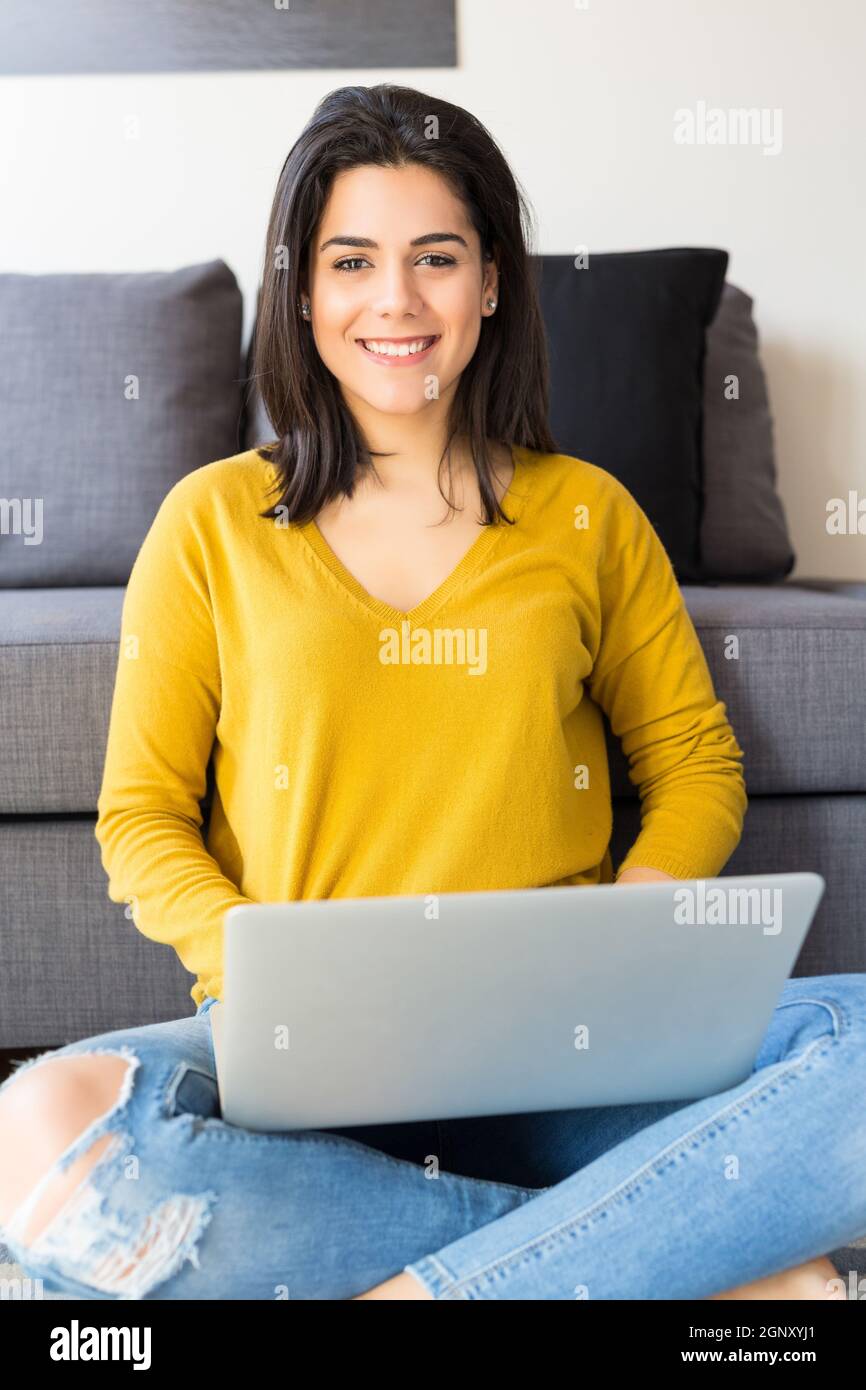 Beautiful woman relaxing with a computer Stock Photo - Alamy