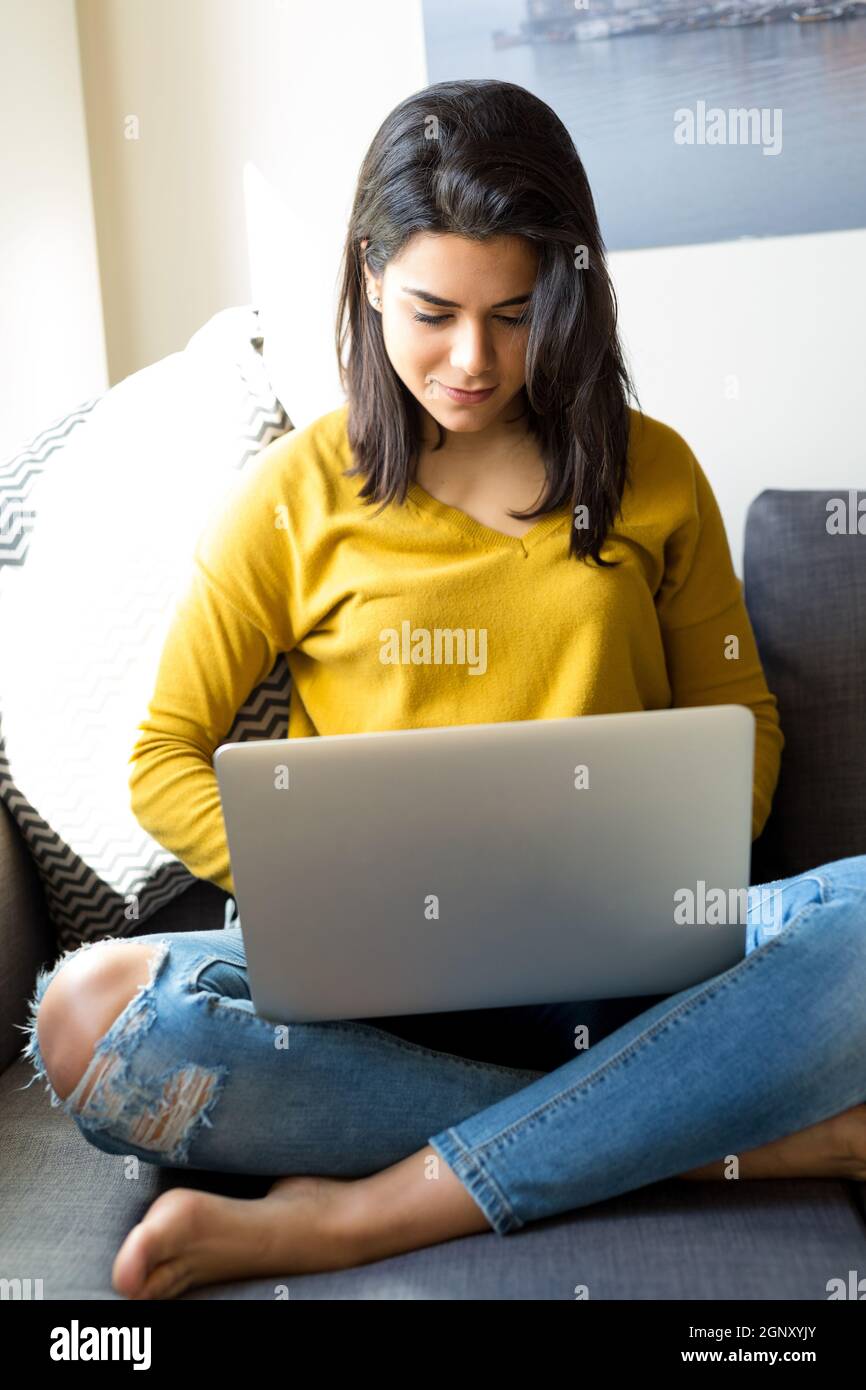 Beautiful woman relaxing with a computer Stock Photo - Alamy