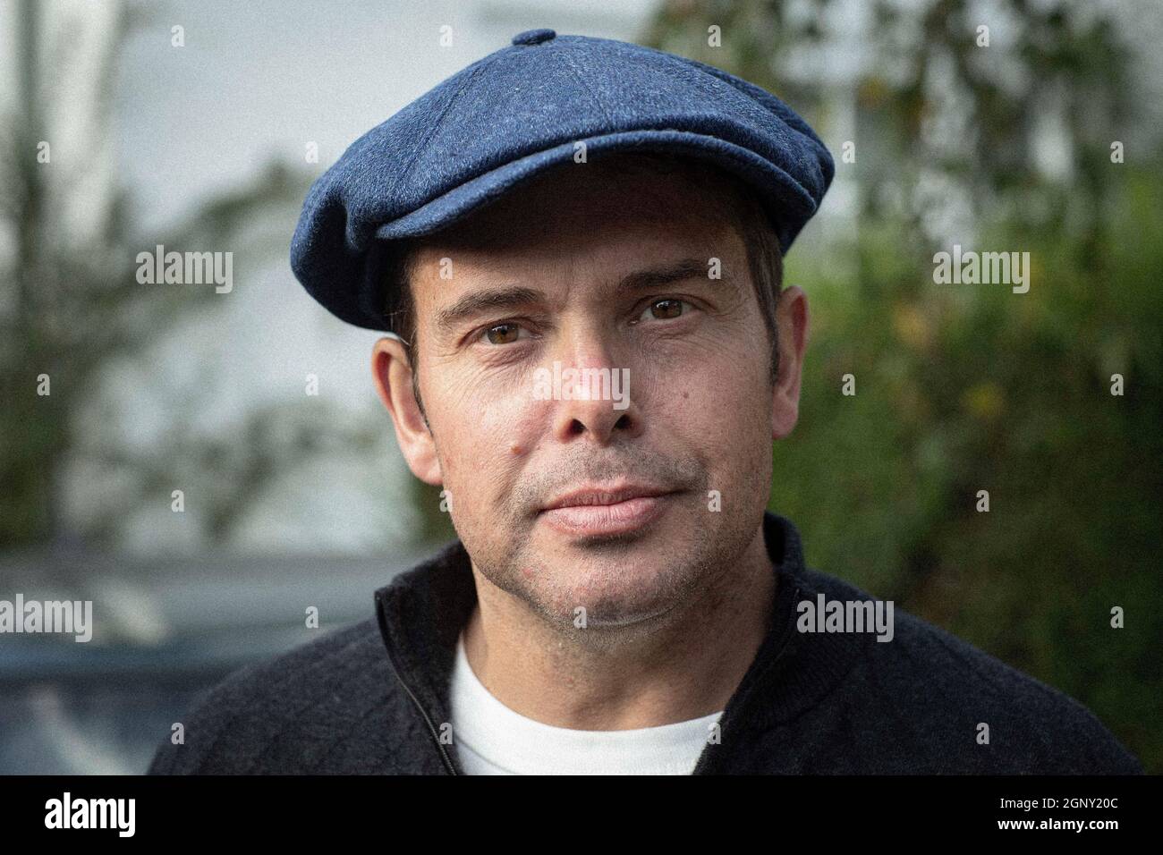 Portrait of good looking man with flat cap Stock Photo