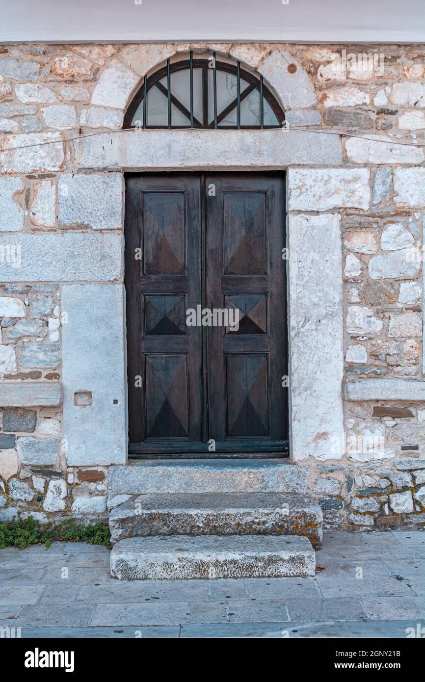 Old architecture stone house with black wooden door Stock Photo - Alamy
