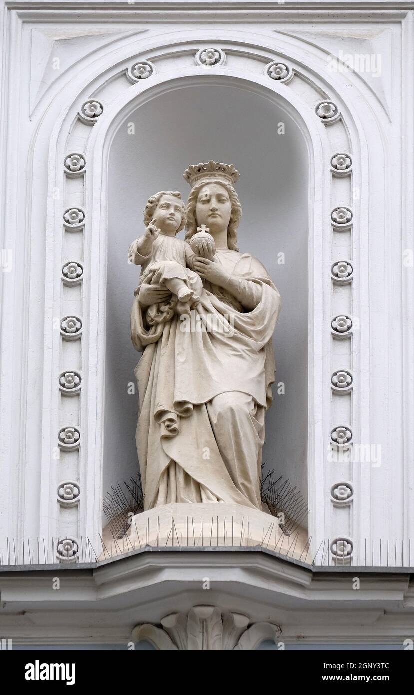 Virgin Mary with baby Jesus, statue on the house facade in Graz, Styria ...