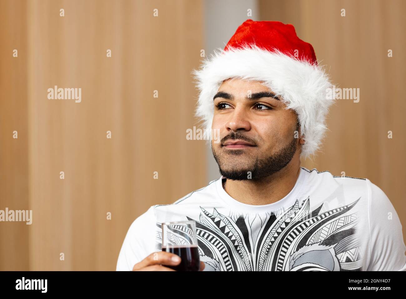 Young african american man in Santa cap drinking red wine Stock Photo ...