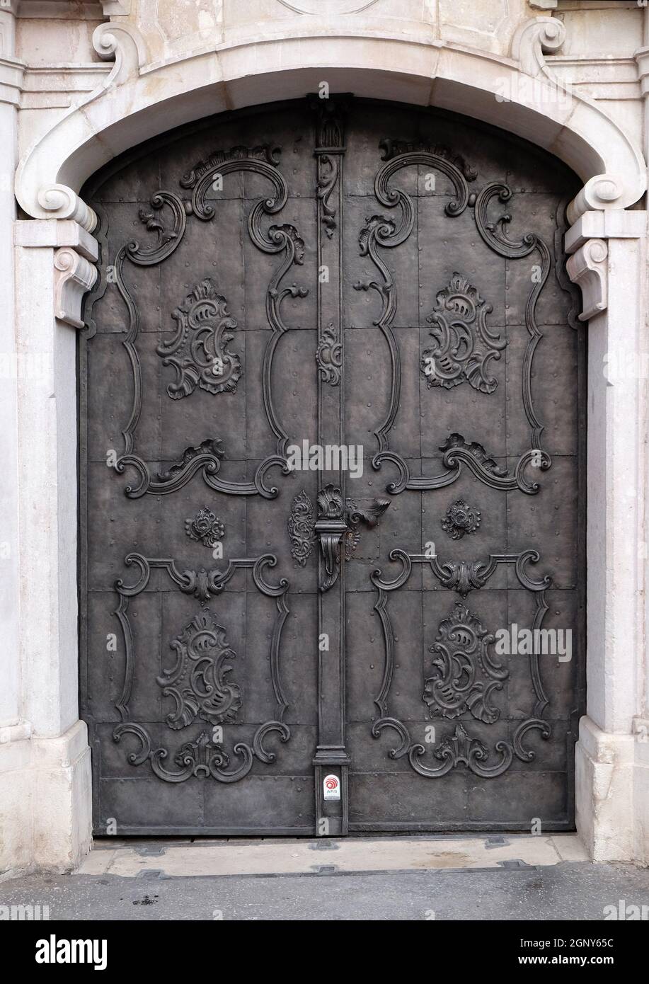 Majestic medieval door with ornate metal pattern and stone columns in ...