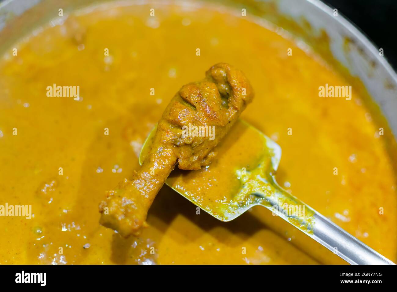 Chicken leg piece with Butter chicken gravy during the serving. Used selective focus. Stock Photo