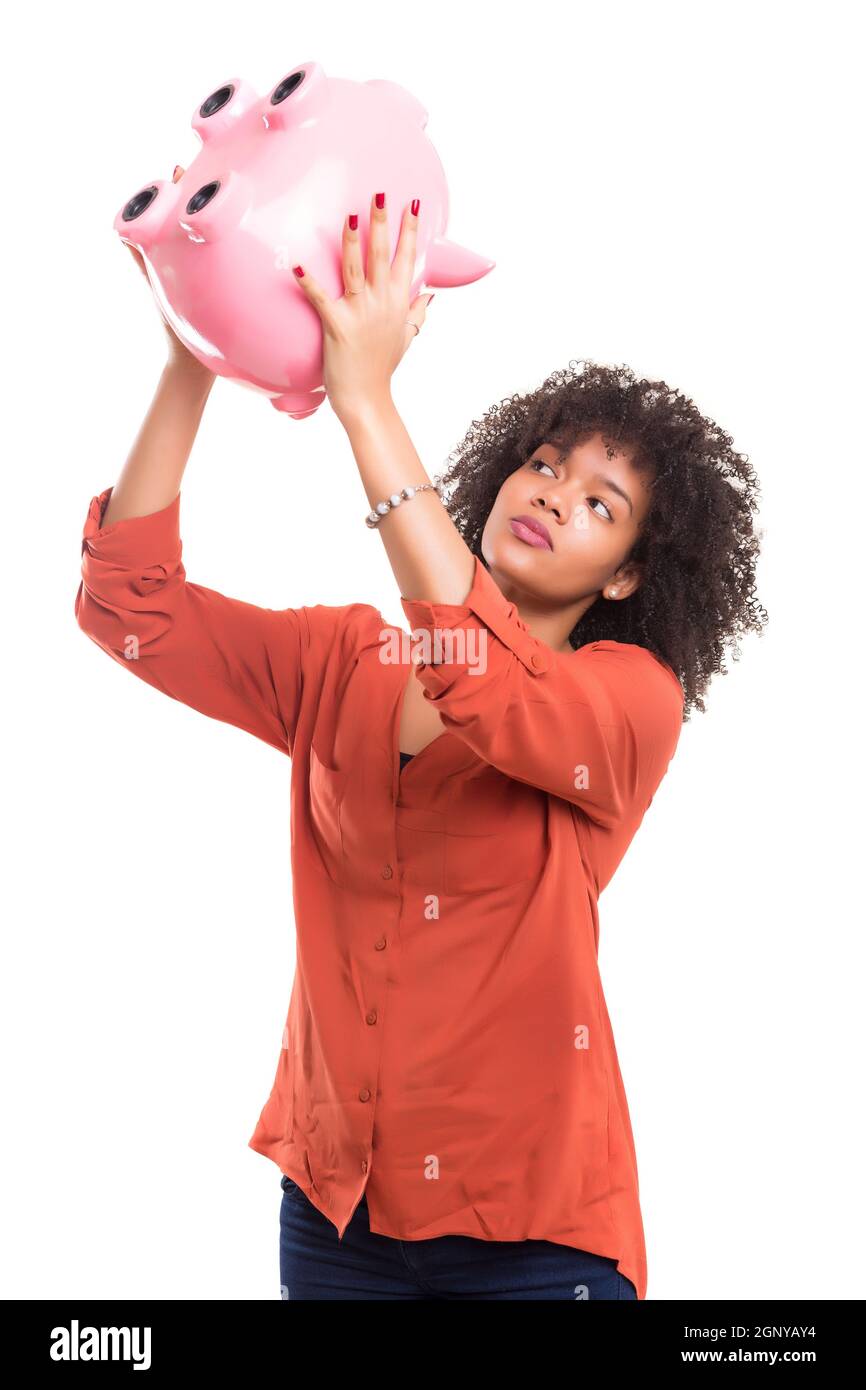 African woman trying to get some money out of a piggy bank Stock Photo ...