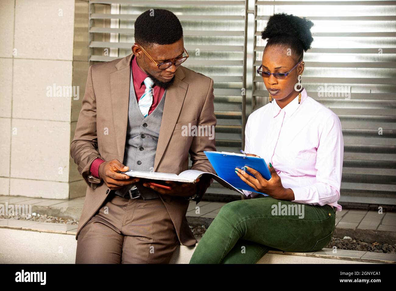 young business people talking and holding project documents in hand Stock Photo