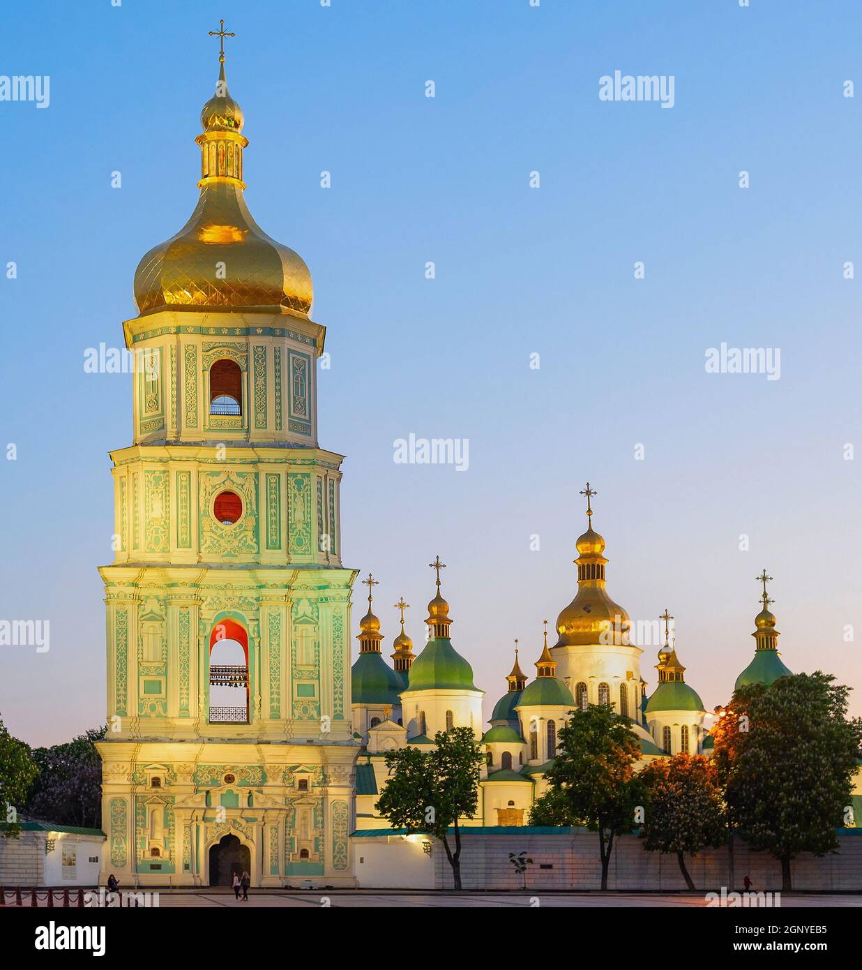 Saint Sophia's Cathedral with bell tower view at twilight, blooming chestnut trees and afterglow sky in background, Kyiv, Ukraine Stock Photo
