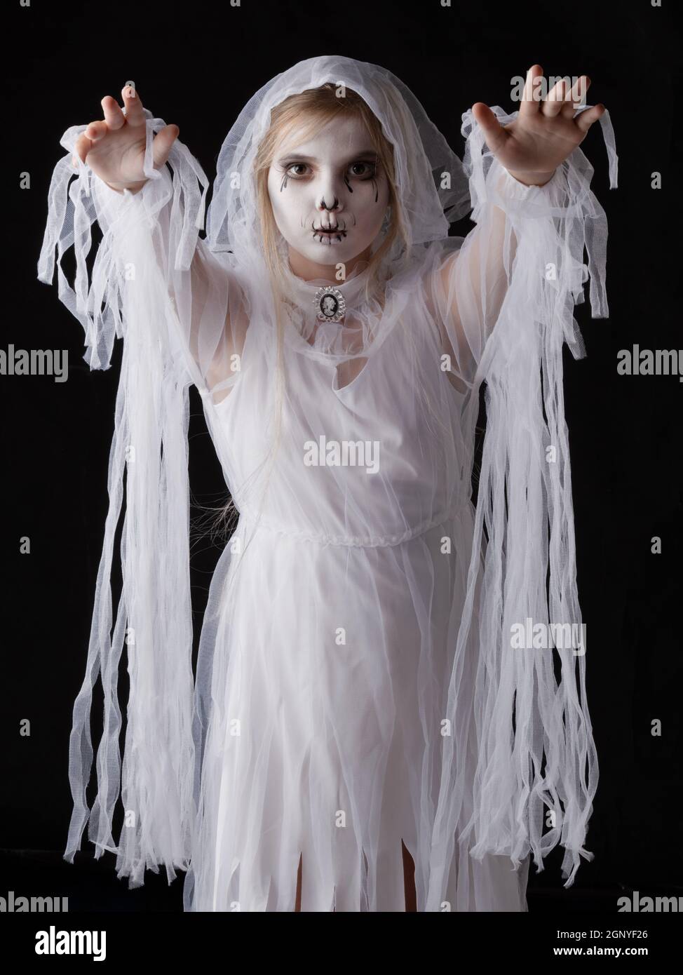 Little girl in Halloween ghost costume walking on you, studio isolated on black background Stock Photo