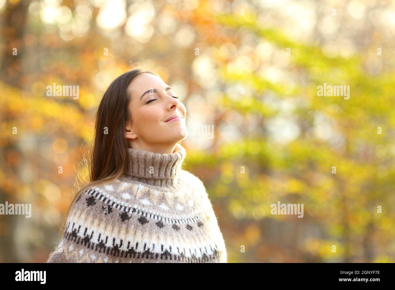 Relaxed woman breathing fresh air standing in a park in winter Stock ...