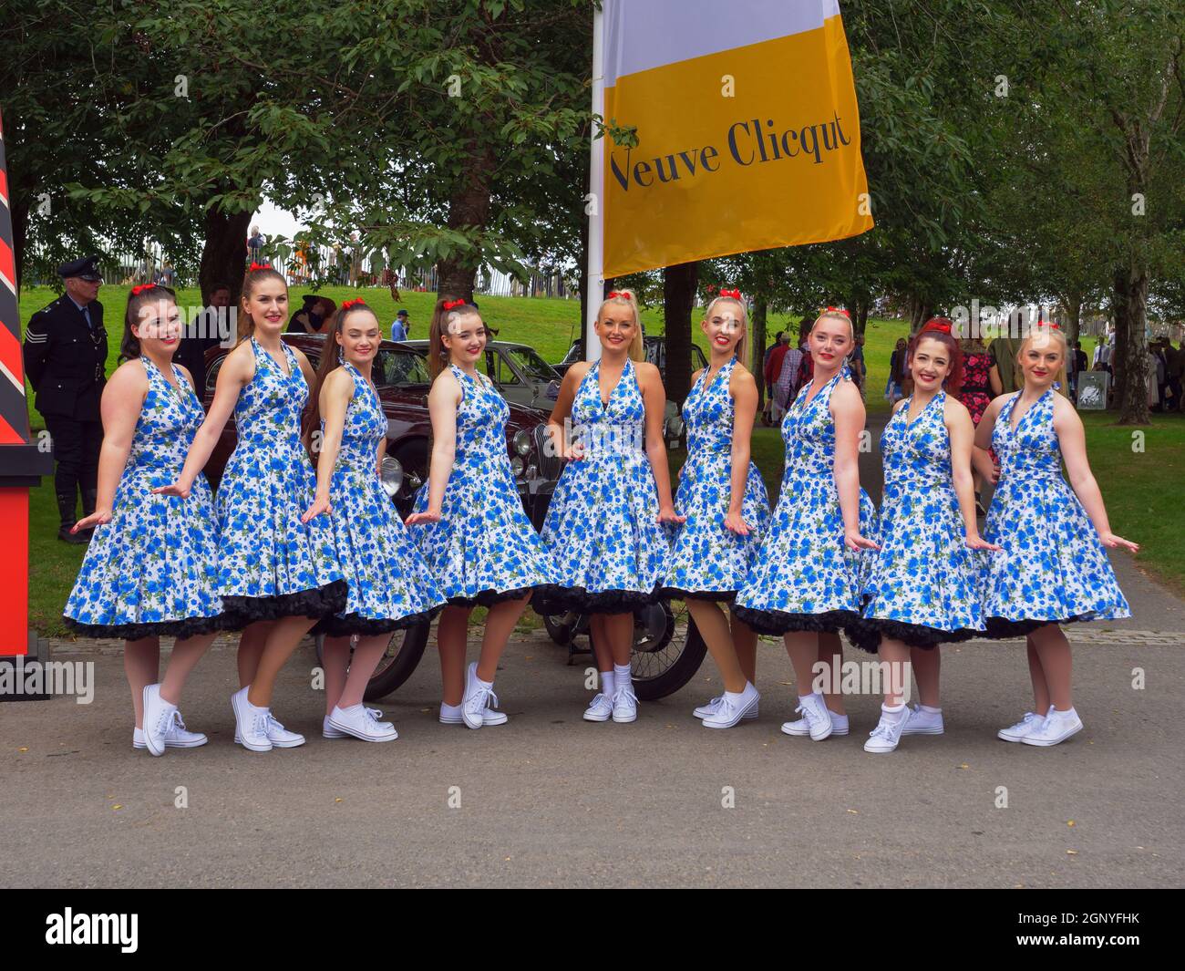 Pretty girls in blue dresses in a line at the Goodwood Revival 2021 Stock Photo