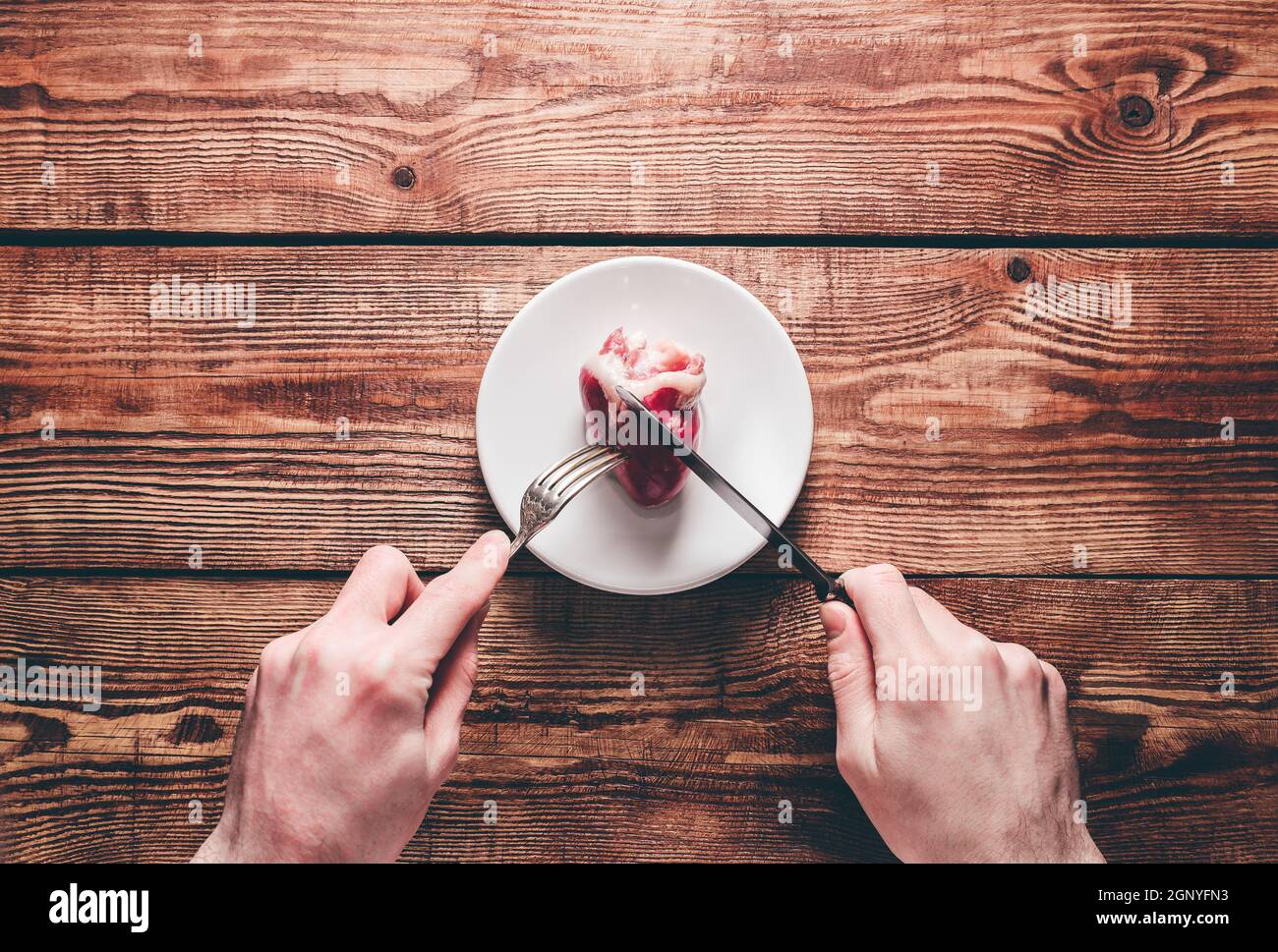 heart-on-plate-two-hands-cut-heart-with-silverware-stock-photo-alamy