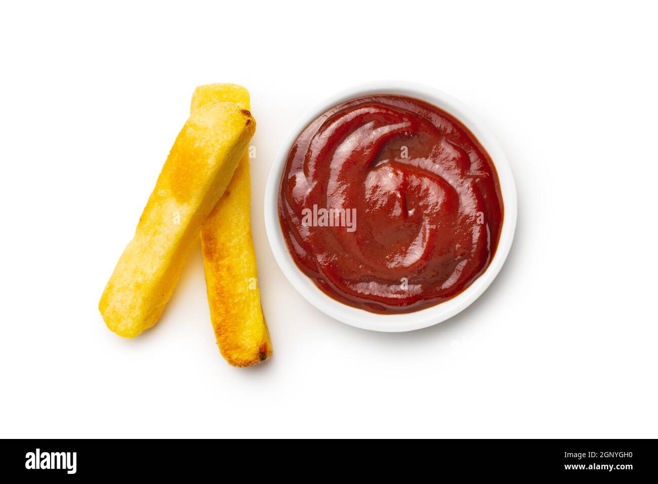 Big french fries. Fried potato chips with ketchup isolated on white background. Stock Photo