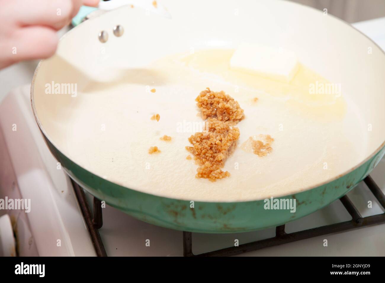 Roasted minced garlic and butter in a frying pan Stock Photo Alamy