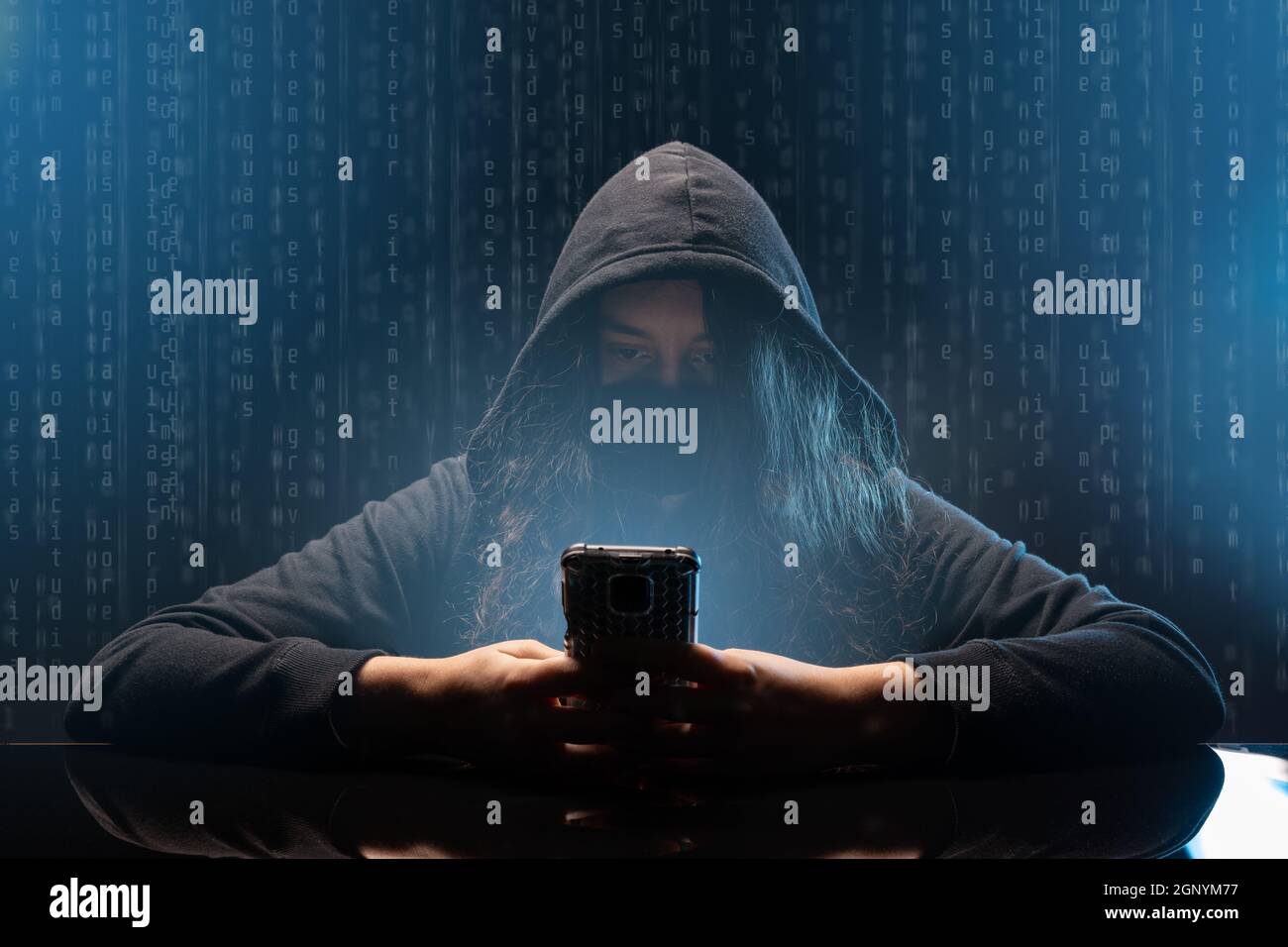 Hacker with cellphone. Young woman using dark web with smartphone. Stock Photo